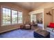 Spacious living room with large windows, mirrored closet, and comfortable seating at 8380 Se 7Th Avenue Rd, Ocala, FL 34480