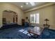 Spacious living room features a vaulted ceiling, blue carpet and large windows at 8380 Se 7Th Avenue Rd, Ocala, FL 34480