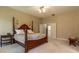 Spacious primary bedroom with hardwood furniture, ensuite bathroom, and plenty of natural light at 8380 Se 7Th Avenue Rd, Ocala, FL 34480