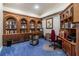 Office space with wooden built-in bookcases, cabinets and blue carpet at 8380 Se 7Th Avenue Rd, Ocala, FL 34480