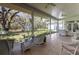 Spacious screened-in patio with comfortable seating and beautiful views of the landscaped backyard and gazebo at 8380 Se 7Th Avenue Rd, Ocala, FL 34480