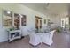 Inviting covered patio with wicker furniture, ceiling fans and ample space for outdoor entertaining at 8380 Se 7Th Avenue Rd, Ocala, FL 34480