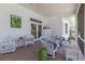 Relaxing screened-in patio area with outdoor seating and views of the lush backyard at 8380 Se 7Th Avenue Rd, Ocala, FL 34480