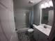 Clean bathroom with a white vanity, patterned floor tiles, and a shower-tub combination at 8890 Sw 33Rd Ct, Ocala, FL 34476