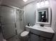 Charming bathroom with a glass-enclosed shower, patterned tile floors, and updated vanity at 8890 Sw 33Rd Ct, Ocala, FL 34476