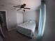 Comfortable bedroom featuring a ceiling fan, closet, and a cozy bed with patterned bedding at 8890 Sw 33Rd Ct, Ocala, FL 34476