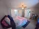 Cozy bedroom featuring a ceiling fan, an ensuite bathroom, and a walk-in closet at 8890 Sw 33Rd Ct, Ocala, FL 34476