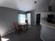 Functional kitchenette with counter seating, white cabinets, and tile flooring at 8890 Sw 33Rd Ct, Ocala, FL 34476