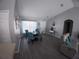 Bright and airy living room with gray floors, a round table, and a comfortable recliner at 8890 Sw 33Rd Ct, Ocala, FL 34476