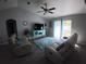 Comfortable living room with recliners, plush rug, and a ceiling fan at 8890 Sw 33Rd Ct, Ocala, FL 34476