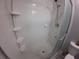 A clean, bright shower with a built-in corner shelf and glass door at 8890 Sw 33Rd Ct, Ocala, FL 34476