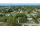 Aerial view showcases cozy home neighborhood, surrounded by lush trees, with paved roads at 8917 Sw 101St Ln, Ocala, FL 34481