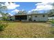 The backyard features a lawn, foliage and a screened-in lanai at 8917 Sw 101St Ln, Ocala, FL 34481