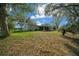 Back of house with a spacious lawn and foliage at 8917 Sw 101St Ln, Ocala, FL 34481