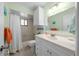 Bright bathroom with a shower-tub combination, vanity with storage, and decorative accents at 8917 Sw 101St Ln, Ocala, FL 34481