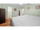 Relaxing bedroom features hardwood floors, a ceiling fan, and adjacent walk-in closet and bathroom at 8917 Sw 101St Ln, Ocala, FL 34481