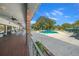 Outdoor patio overlooking the community pool with ceiling fans, brick columns, and tables and chairs at 8917 Sw 101St Ln, Ocala, FL 34481