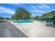 Expansive community pool area featuring numerous lounge chairs for relaxation and recreation under a clear blue sky at 8917 Sw 101St Ln, Ocala, FL 34481