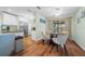 Dining area adjacent to kitchen with hardwood floors and access to lanai at 8917 Sw 101St Ln, Ocala, FL 34481