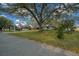 Attractive single-story home with a well-manicured lawn, mature trees, and an American flag displayed in the front yard at 8917 Sw 101St Ln, Ocala, FL 34481