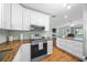 Bright, renovated kitchen with white cabinets, stainless steel appliances, and granite countertops, ready for cooking at 8917 Sw 101St Ln, Ocala, FL 34481