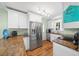 Updated kitchen boasts stainless steel appliances, granite countertops, and white cabinets at 8917 Sw 101St Ln, Ocala, FL 34481