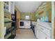 The laundry room includes a washer, dryer, shelving and counter space for laundry needs at 8917 Sw 101St Ln, Ocala, FL 34481