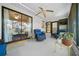 A screened-in porch with tile flooring, fan, and wicker furniture provides a relaxing outdoor space at 8917 Sw 101St Ln, Ocala, FL 34481