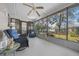 An airy screened porch features tile flooring and comfortable wicker seating to enjoy the outdoors at 8917 Sw 101St Ln, Ocala, FL 34481
