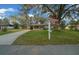 Comfortable home featuring a carport, well-maintained lawn, and an American flag, symbolizing pride and welcome at 8917 Sw 101St Ln, Ocala, FL 34481