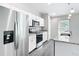 Modern kitchen featuring stainless steel appliances, granite countertops, and white cabinetry at 9739 Sw 196Th Cir, Dunnellon, FL 34432