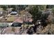 Aerial view of the home set amidst mature trees, showing the roof, yard, outbuildings and surrounding land at 10370 Sw 110Th St, Dunnellon, FL 34432