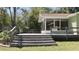 Large wooden deck with screen door and railings, perfect for outdoor entertaining at 10370 Sw 110Th St, Dunnellon, FL 34432