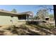 Backyard view featuring a screened-in porch, wooden deck and lush green lawn at 10370 Sw 110Th St, Dunnellon, FL 34432