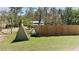 Large backyard with partial fence, propane tanks, and ample space at 10370 Sw 110Th St, Dunnellon, FL 34432