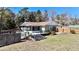 Home with wooden deck and screened in patio overlooking a well maintained backyard with board fencing at 10370 Sw 110Th St, Dunnellon, FL 34432