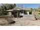 Patio area with a stone fire pit next to the large deck with screen door at 10370 Sw 110Th St, Dunnellon, FL 34432