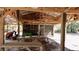 Picnic table and tractor stored underneath an open Barn shelter with lots of storage at 10370 Sw 110Th St, Dunnellon, FL 34432