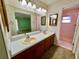 Bathroom featuring a double sink vanity and a separate shower room at 10370 Sw 110Th St, Dunnellon, FL 34432