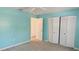 Vibrant bedroom with blue walls, carpet flooring, and bi-fold closet doors at 10370 Sw 110Th St, Dunnellon, FL 34432