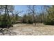 Home nestled among mature trees, offering a serene setting with natural landscaping and ample yard space at 10370 Sw 110Th St, Dunnellon, FL 34432