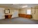 Garage features carpeted floor, cabinets, storage shelves, and a pegboard wall at 10370 Sw 110Th St, Dunnellon, FL 34432