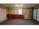 Garage features a carpeted floor, storage cabinets, workbench, and pegboard wall at 10370 Sw 110Th St, Dunnellon, FL 34432