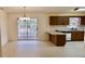 Eat-in kitchen with dark wood cabinets, a breakfast bar, and sliding doors to the screened in porch at 10370 Sw 110Th St, Dunnellon, FL 34432