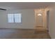 Carpeted living room features a ceiling fan and a large window for natural light at 10370 Sw 110Th St, Dunnellon, FL 34432