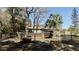 View of fenced paddocks, creating dedicated spaces for animals within a scenic, wooded area at 10370 Sw 110Th St, Dunnellon, FL 34432