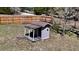 Charming playhouse with a covered porch, set against a backdrop of lush greenery and privacy fence at 10370 Sw 110Th St, Dunnellon, FL 34432