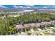 Picturesque aerial view of homes nestled among trees, with a lake in the distance at 1073 Vinsetta Cir, Winter Garden, FL 34787