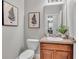 Half bath featuring vanity with granite countertop, modern fixtures, and decorative artwork at 1073 Vinsetta Cir, Winter Garden, FL 34787
