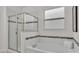 Bathroom showcasing a large soaking tub, glass shower, and tiled walls at 1073 Vinsetta Cir, Winter Garden, FL 34787